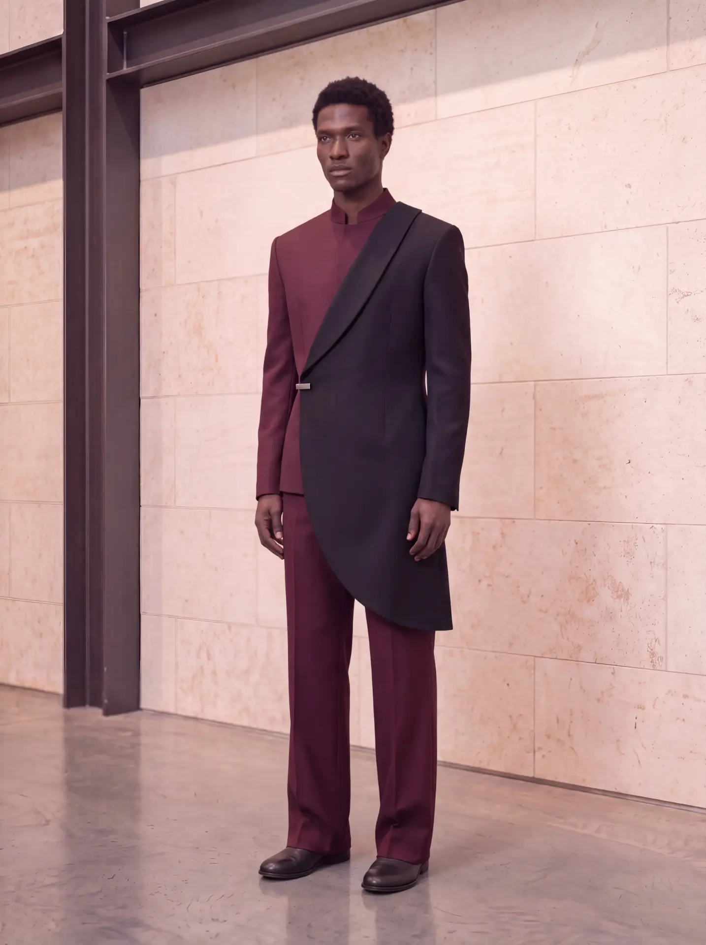 Burgundy ensemble layered under an asymmetric curved black half-coat